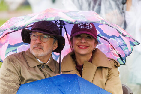 Families watch under umbrellas