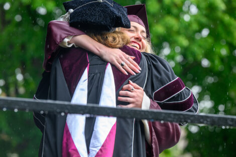 A graduate hugs President Nicole Hurd