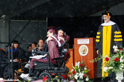 President Nicole Hurd hugs Dexter Kennedy