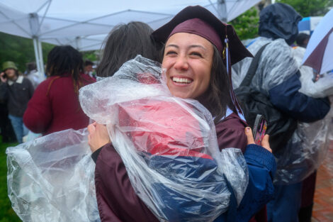 A graduate hugs a family member.