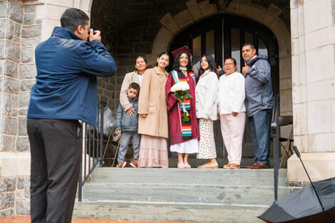 Family members pose with their graduate for a photo