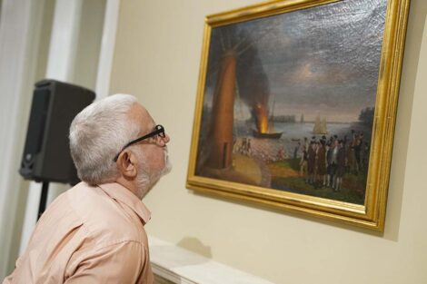 Attendee views a painting