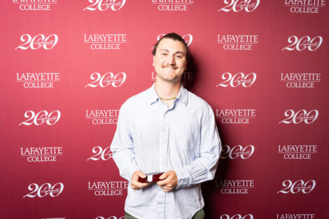 Avery Sichel ’26 is holding a glass award.