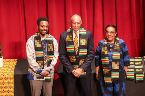 Three attendees at the Donning of the Kente