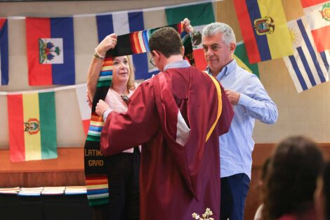 A student gets their sash at Unidos en Celebración
