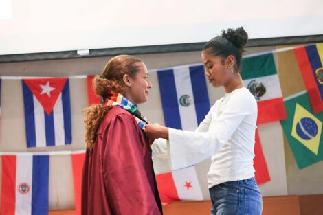 A student gets their sash at Unidos en Celebración