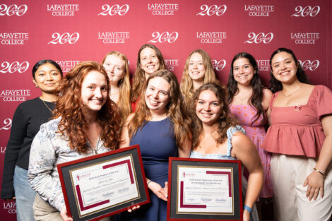 Members of LRAJE are holding two framed awards.