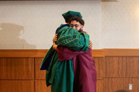 Tim Cox hugs a student at Posse Celebration