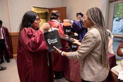 A student receives a bag at Posse Celebration
