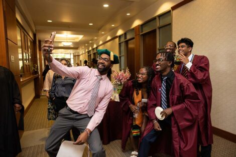 Tim Cox takes a selfie with students at Posse Celebration
