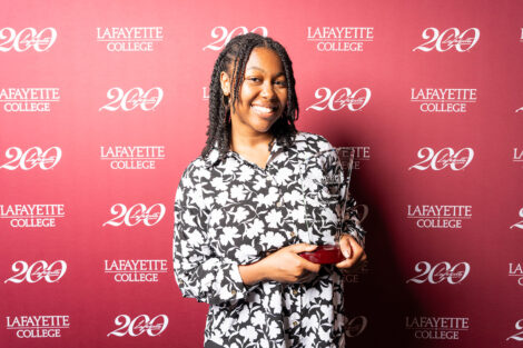 Skyler Chouloute ’28 is holding a glass award.