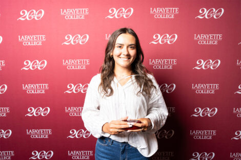 Sophia Lombardo ’26 is holding a glass award.