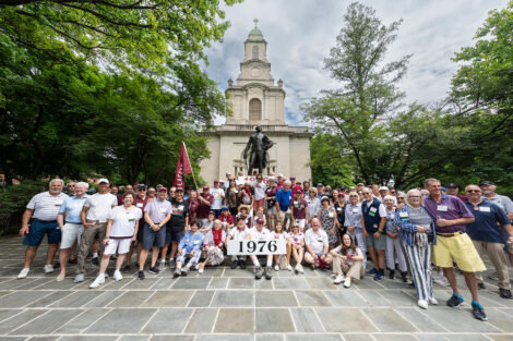 A large group is standing in front of Colton Chapel.