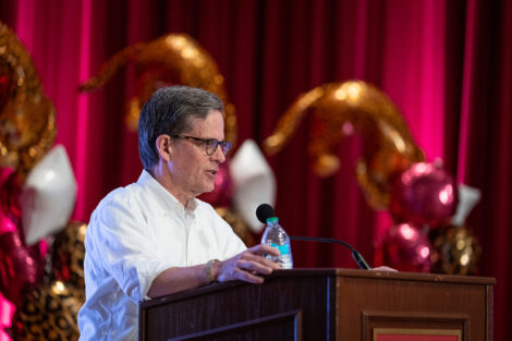 John Mulcahy ’87, P’27, is standing at a podium.