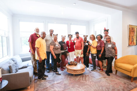 A large group of alumni stand in Portlock Black Cultural Center.