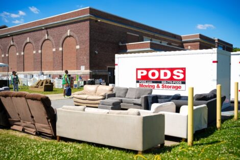 Rows of sofas sit in front of a POD trailer outside Paxinosa Elementary School.