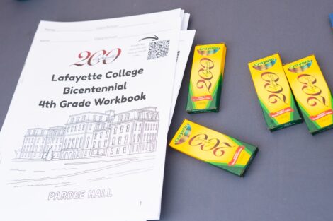 A copy of the Lafayette College Bicentennial 4th Grade workbook is shown with Crayola Bicentennial crayons.