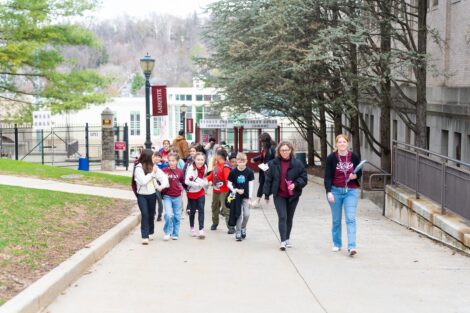 A group of Easton fourth graders walks up from Kirby Sports Center, accomanied by Missy Nerino and Chelsea Morrese.