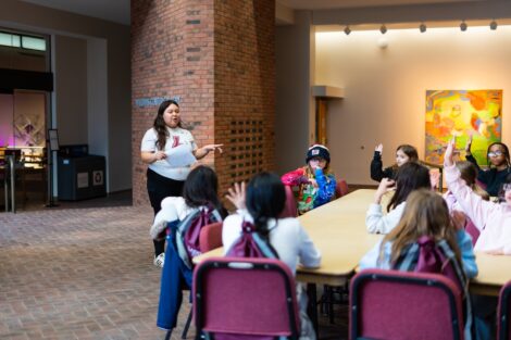 A Lafayette student talks to a group of fourth graders during their visit to Williams Center for the Arts.