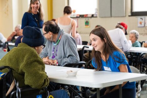 A Lafayette student chats with a Gracedale resident across the table during a POSP event.
