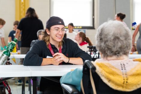 A Lafayette student smiles as they meet a resident at Gracedale.