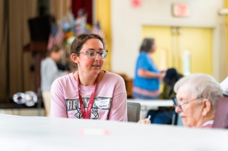 A Lafayette student chats with a Gracedale resident as they enjoy ice cream at a POSP event