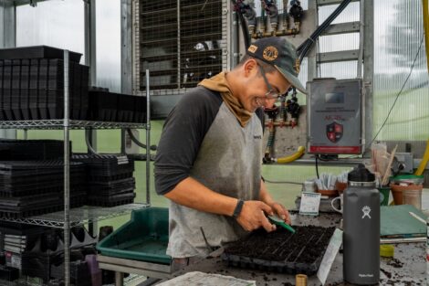 A POSP student tests soil in the greenhouse at LaFarm.