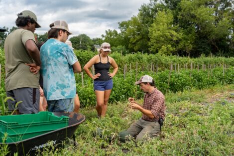 Josh Parr talks with the students participating in POSP as they work in the field.