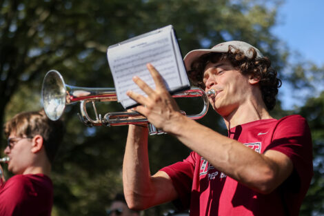 A student plays a trumpet during Move-in weekend.