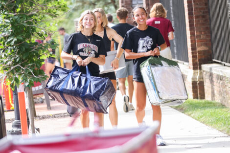 Students carry items to their residence halls.
