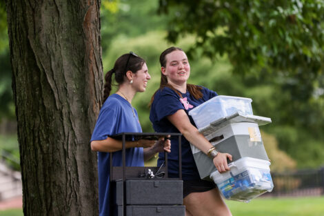 Students carry items to their residence halls.