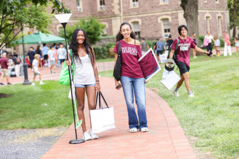 Students carry items to their residence halls.