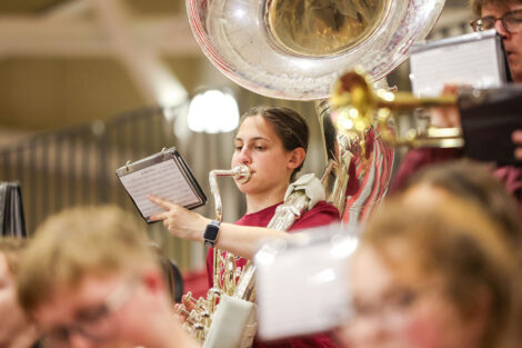 A student plays in the band during Convocation.