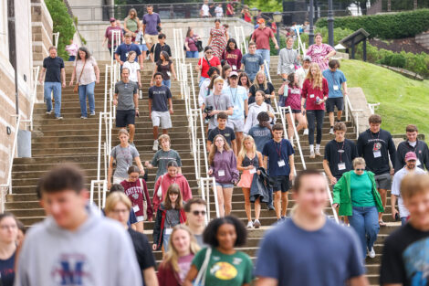 Students and families walk down the stairs next to Kirby Sports Center to attend Convocation.