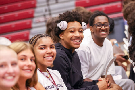 Students share a laugh as they take in the Convocation program.