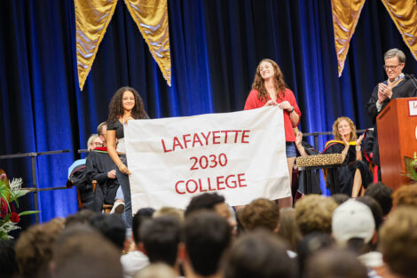 Members of Lafayette College's Class of 2030 raise a class flag.