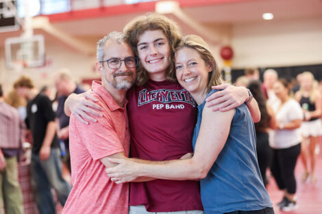 A family gathers for a photo in Kamine Gymnasium.