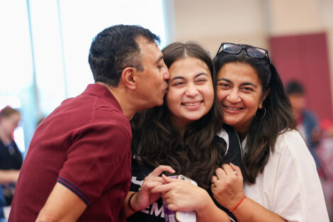 A family shares a a happy group embrace after Convocation.