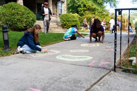 Community members and McKelvy Scholars draw on the sidewalk for ChalkFest.
