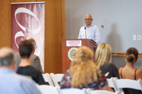Abu Rizvi, professor of economics, speaks to a group.
