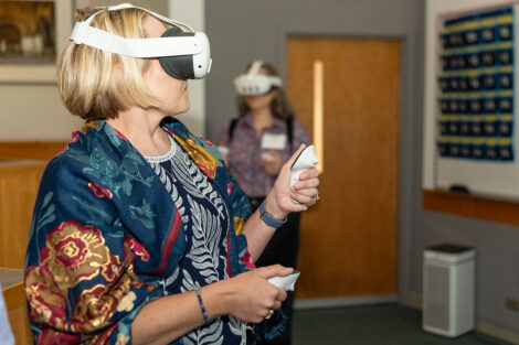 A woman looks through VR glasses during the Bicentennial Symposium.
