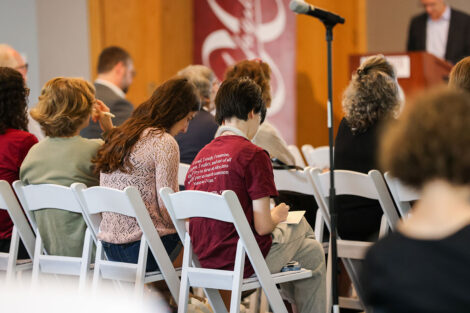 Students take notes during a faculty panel in the Marlo Room